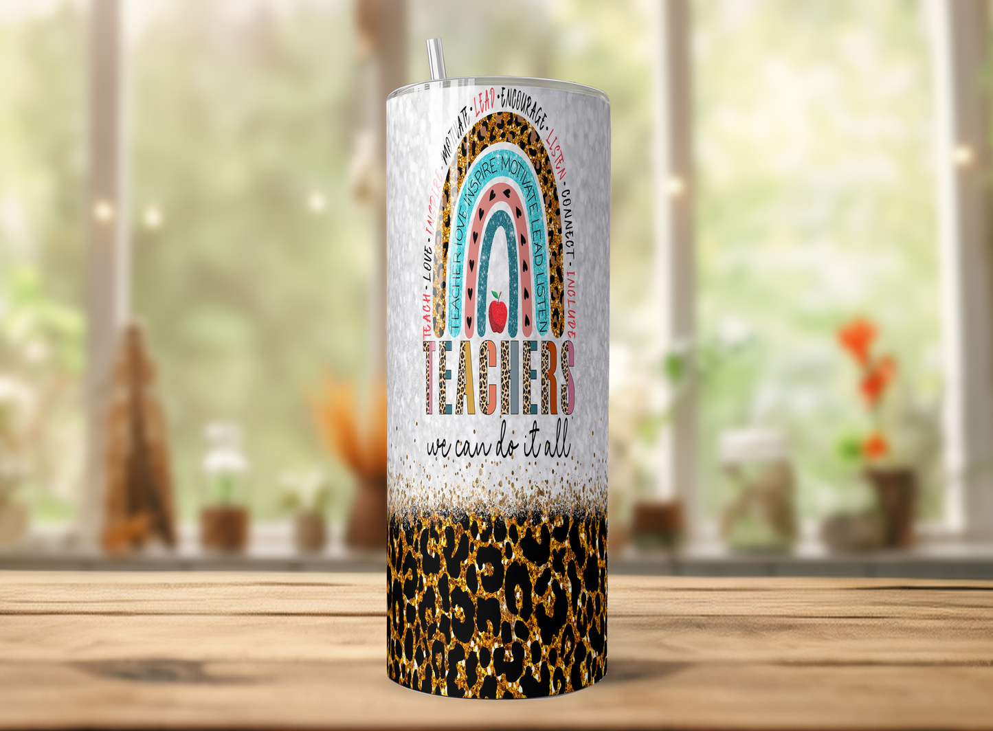 A tumbler with a leopard print design and a rainbow-colored graphic on it, placed on a wooden surface.