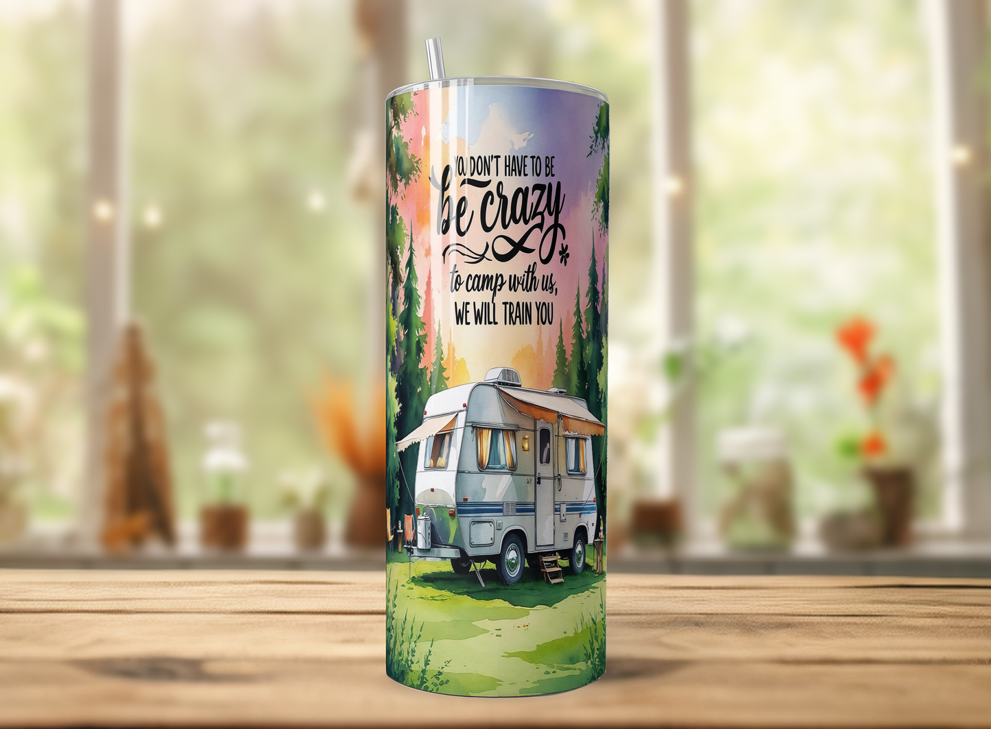 A cylindrical tumbler with a printed design on it, featuring a camper van and a forest scene.