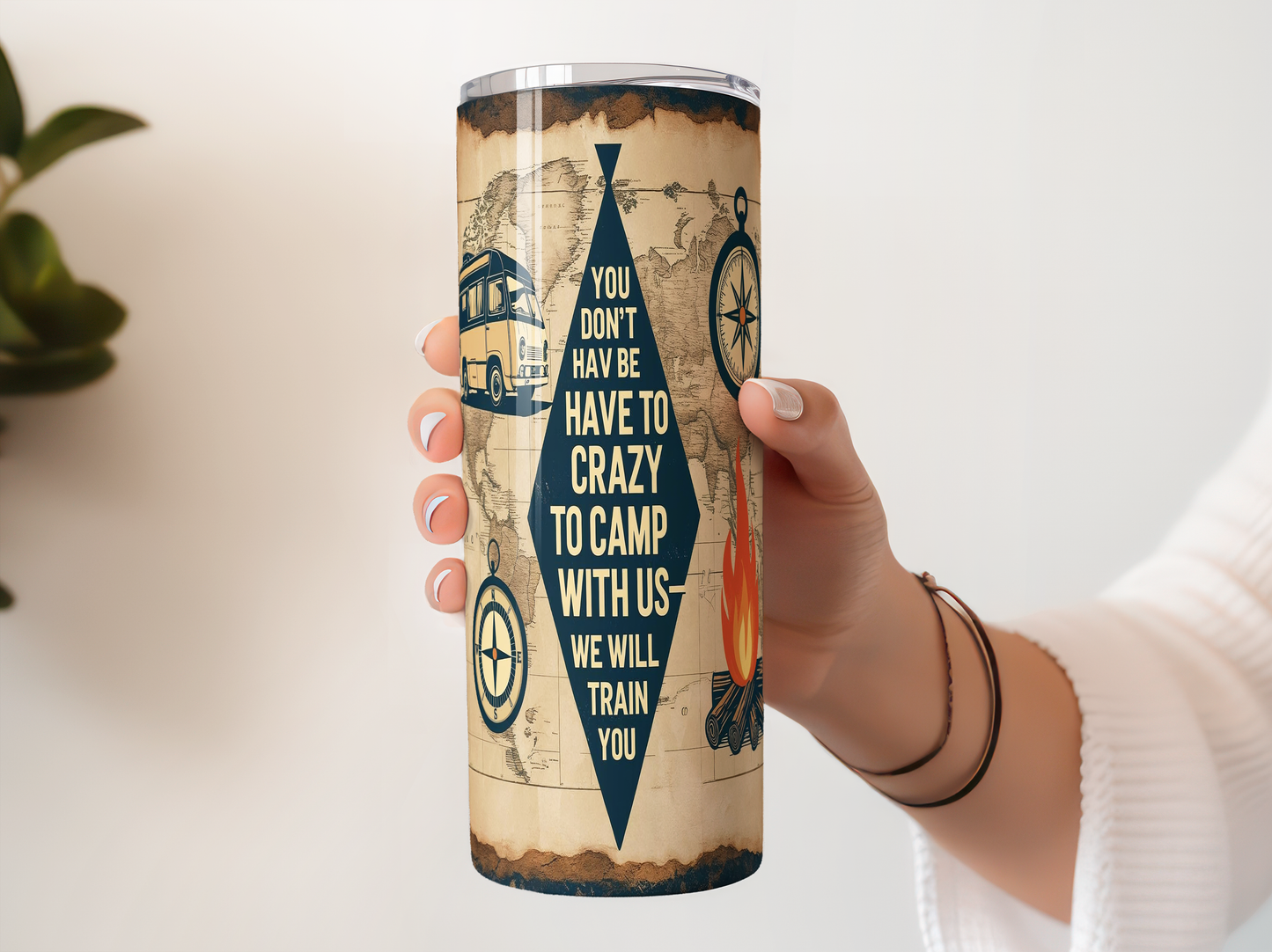 A person's hand holding a cylindrical container with a map design and text printed on it.