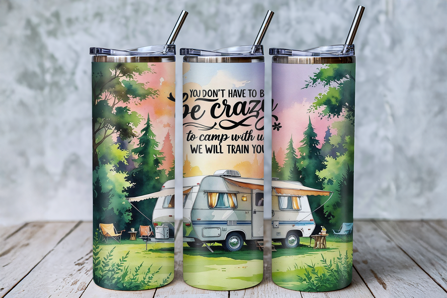 A set of three colorful tumblers with a camping scene printed on them.