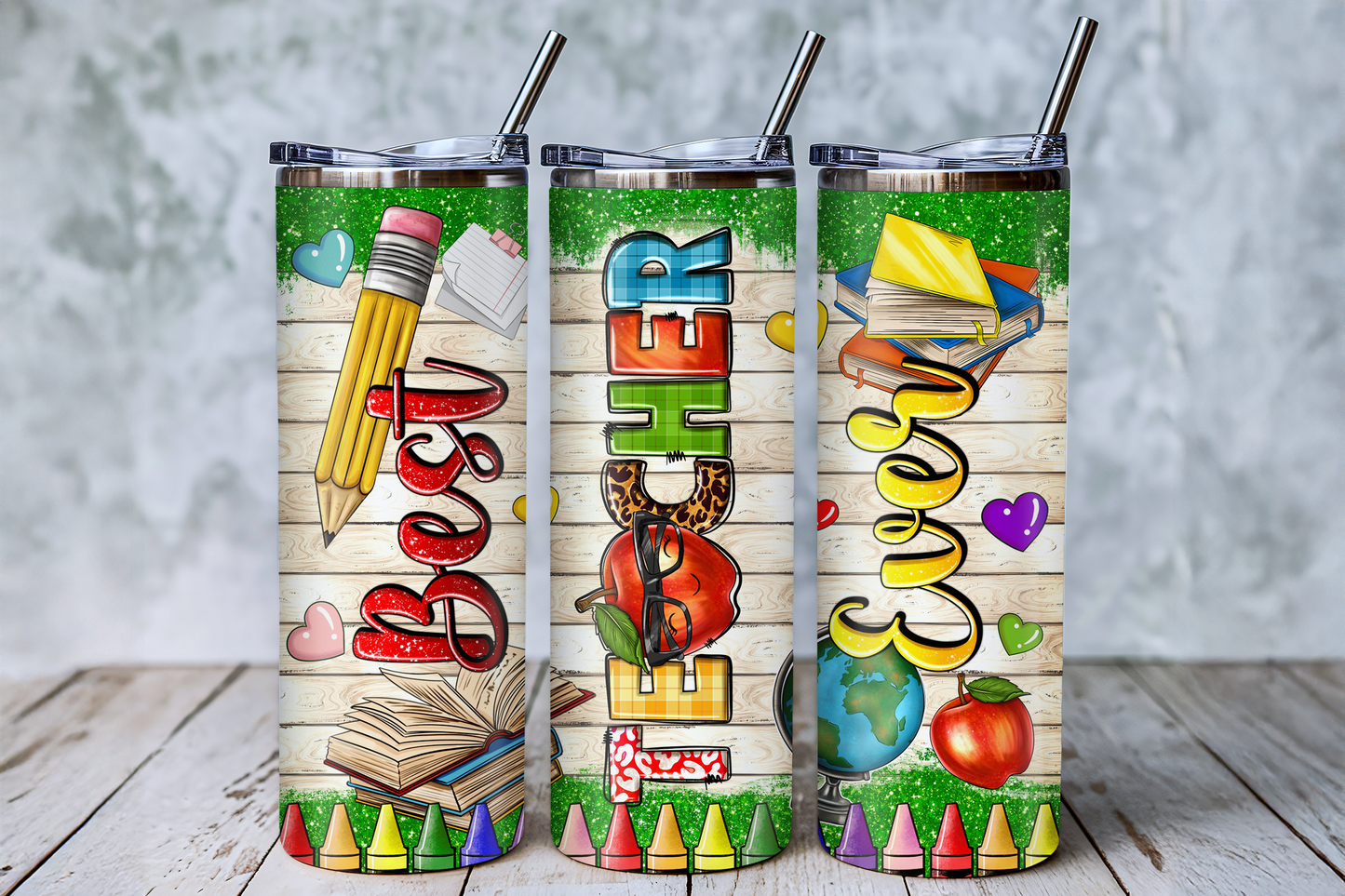 Three colorful tumblers with illustrations of school supplies and the word "EVER" on them.