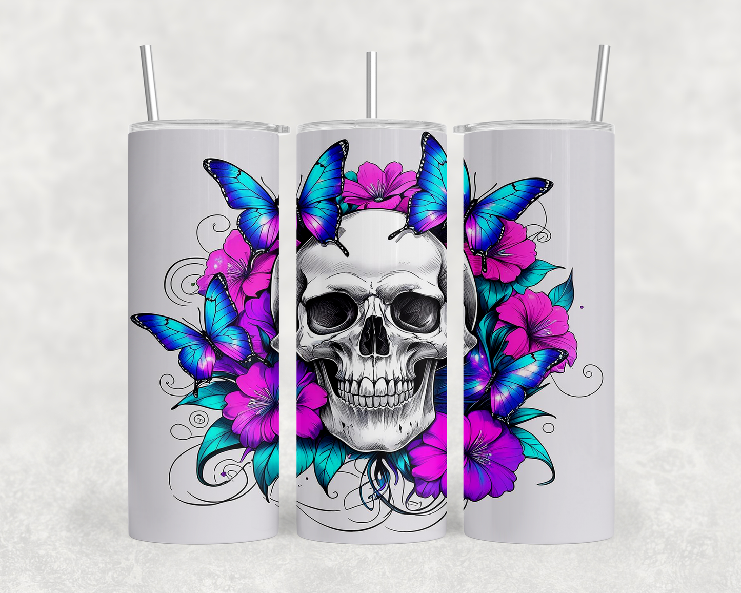 A white tumbler with a skull design surrounded by colorful butterflies and flowers.